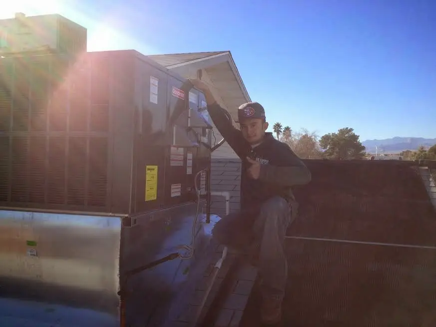 HVAC technician performing AC Tune-Up on a rooftop unit in Loomis